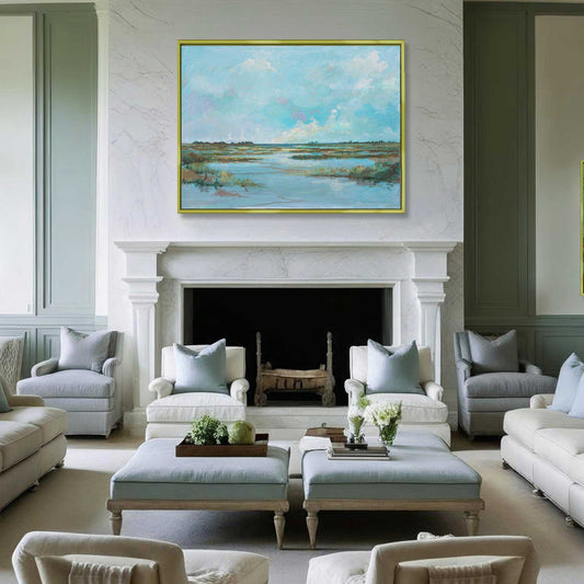 Luxury living room with gray furniture, a fireplace, and a large painting of a coastal landscape by Patrick Reid OBrien.