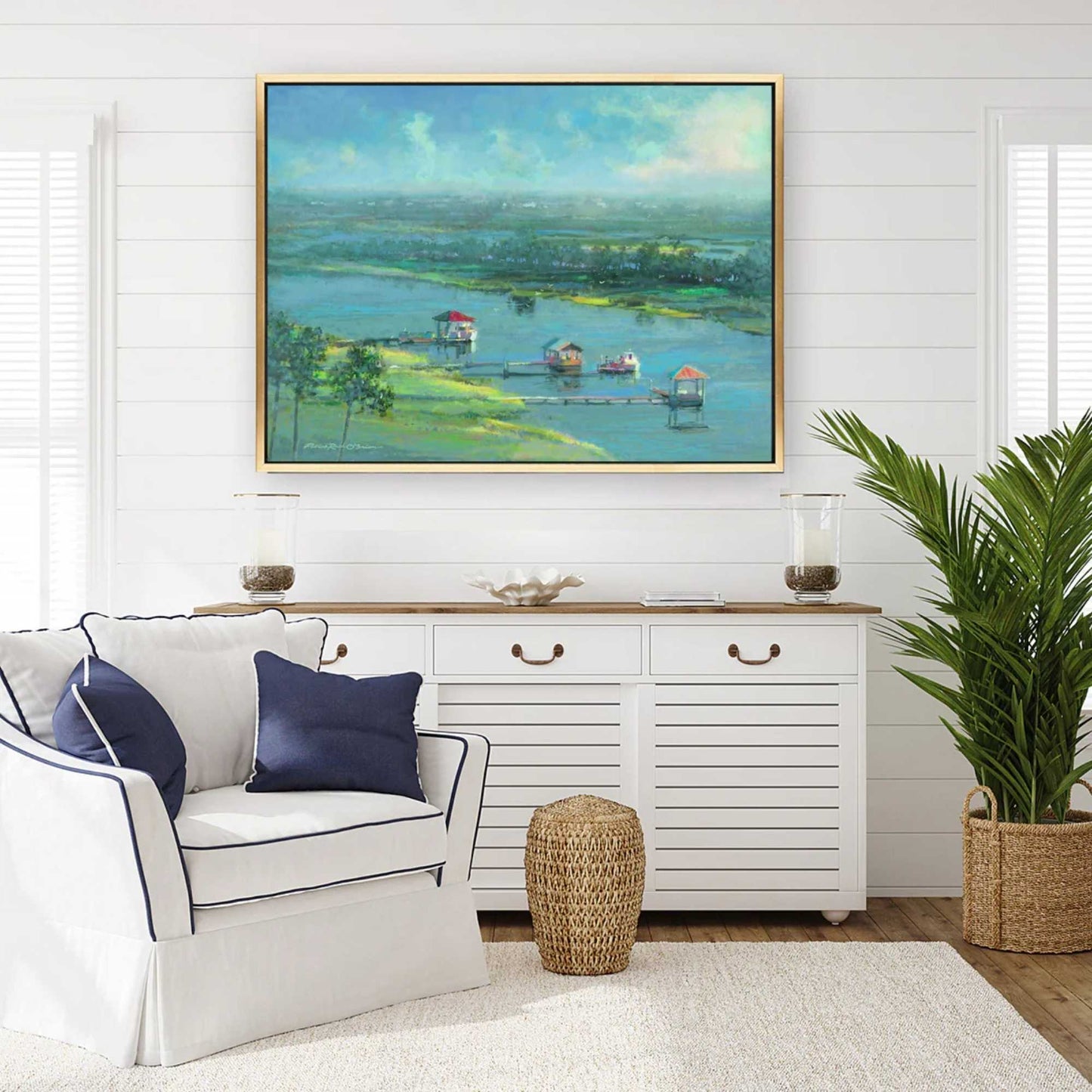 Living room with a white sofa, decorative pillows, a sideboard, and a large landscape by Patrick Reid O'Brien on the wall.