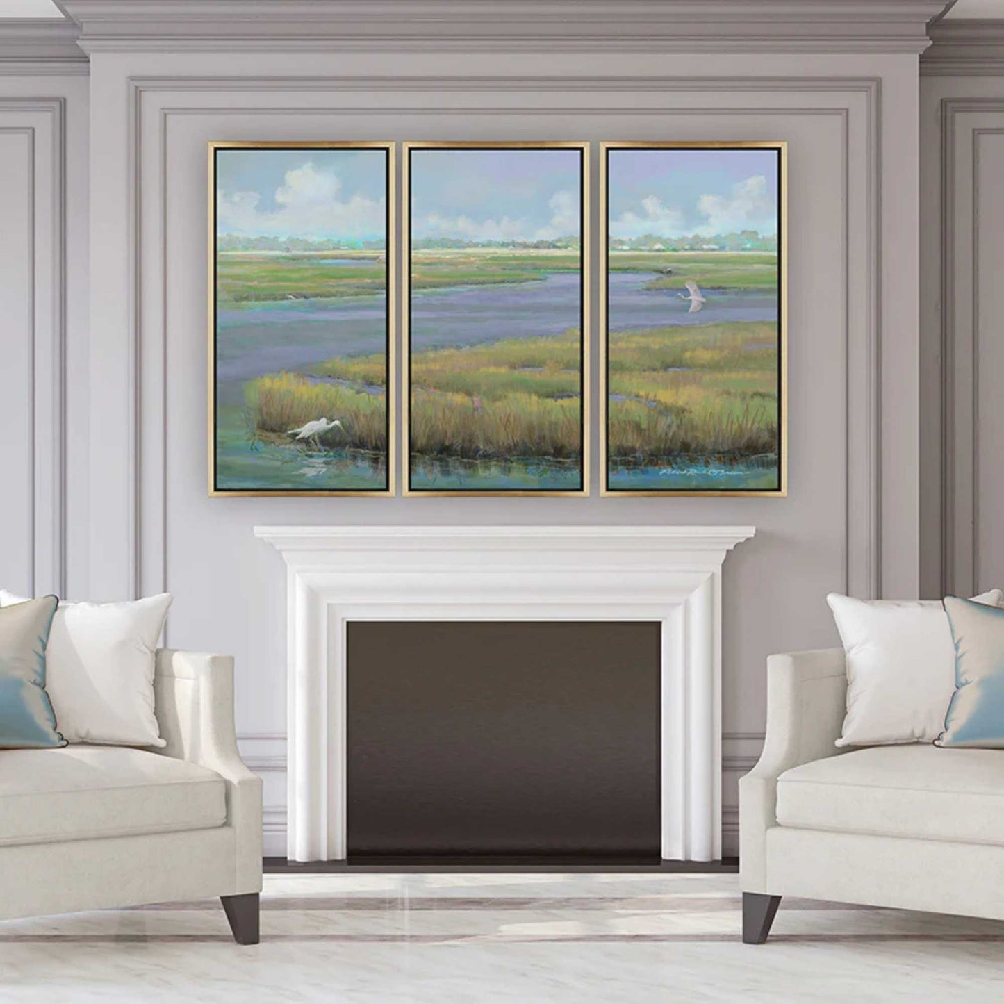 Living room with a fireplace and coastal triptych framed art by Patrick Reid O'Brien depicting Mount Pleasant.