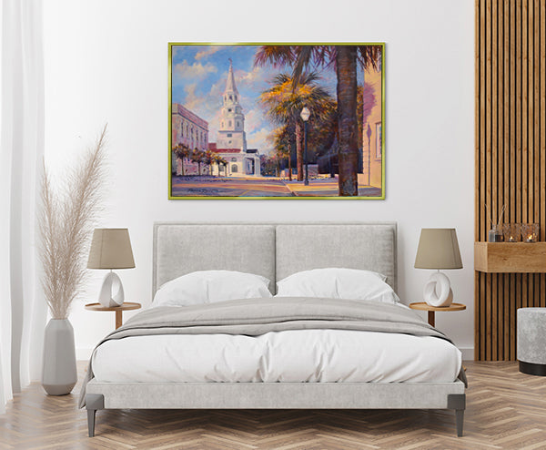 Charleston cityscape by Patrick Reid O'Brien above headboard in coastal neutral bedroom adds a pop of color.