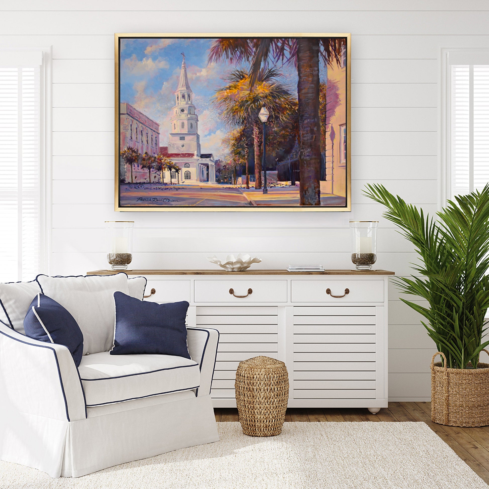 Luxury living room with Shiplap walls and Charleston streetscape by Patrick Reid O'Brien framed in gold float frame ..