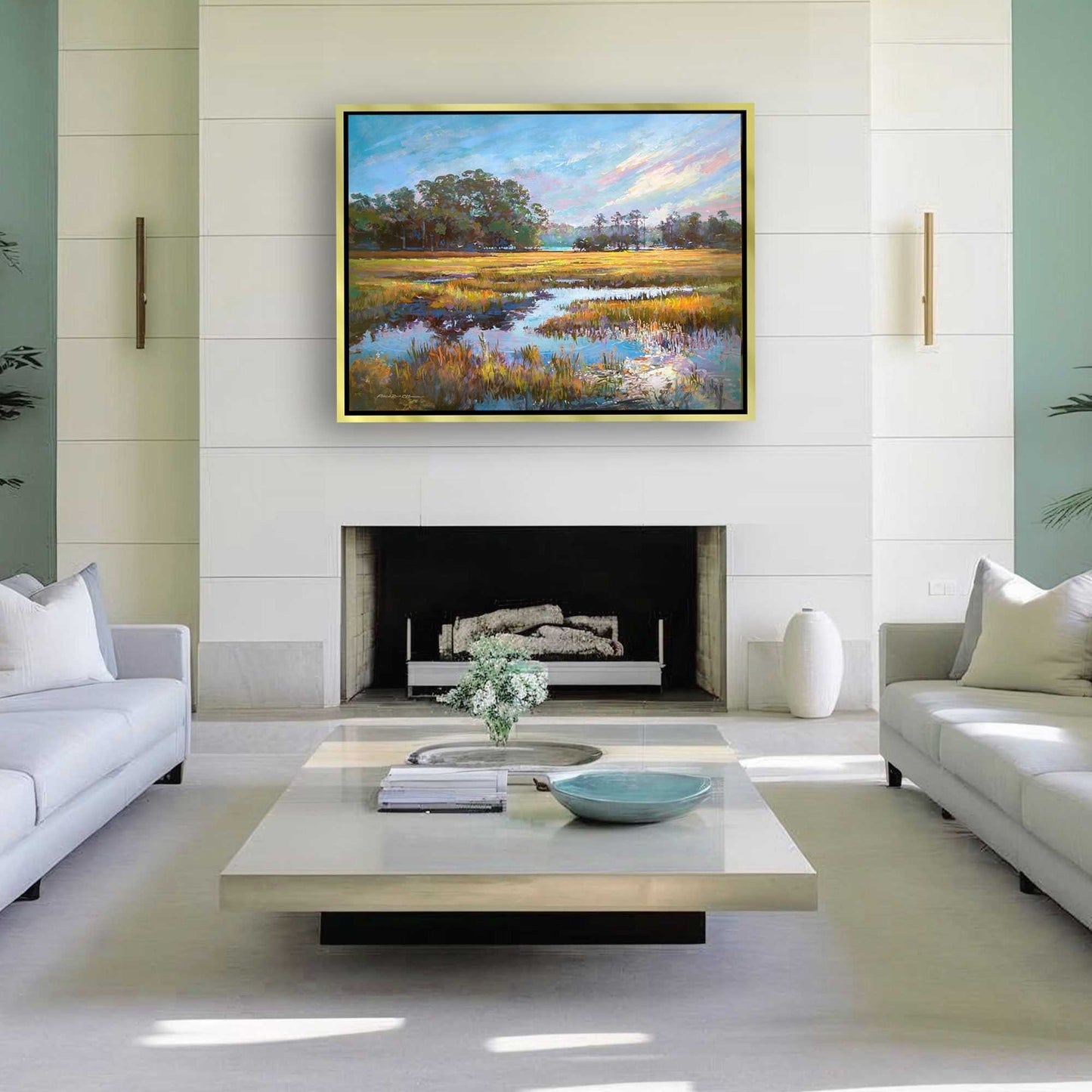 Modern living room with a fireplace, white sofas, and a large painting of a coastal morning landscape by Patrick Reid O'Brien.