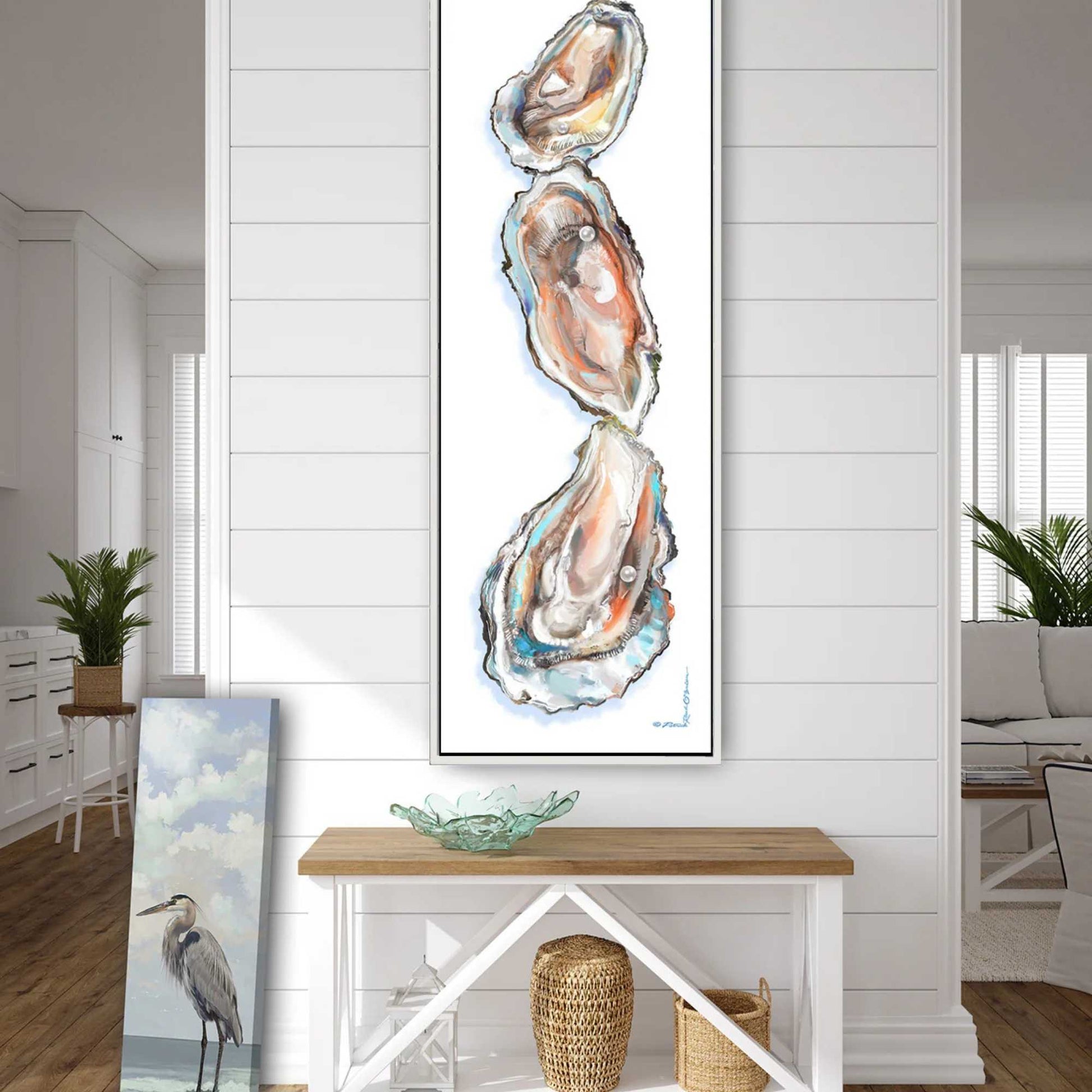 Framed artwork of oyster shells on a wall in a modern living room.